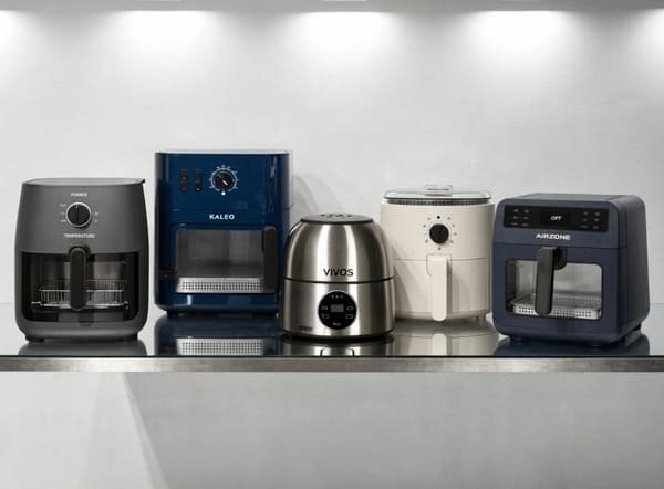 A close-up of a designer's hands sketching a new air fryer design.